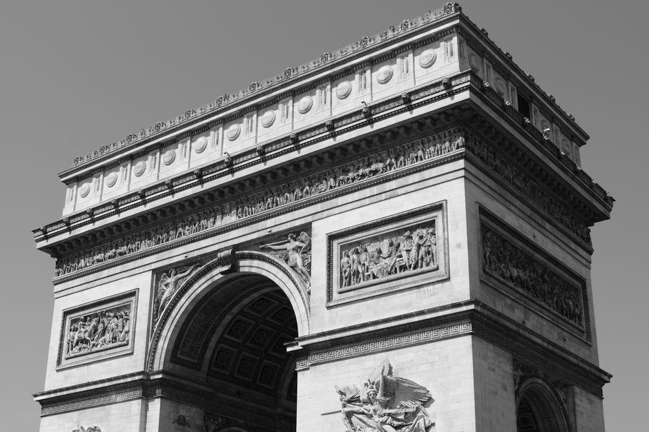 Iconic black and white photograph of the Arc de Triomphe in Paris, France.