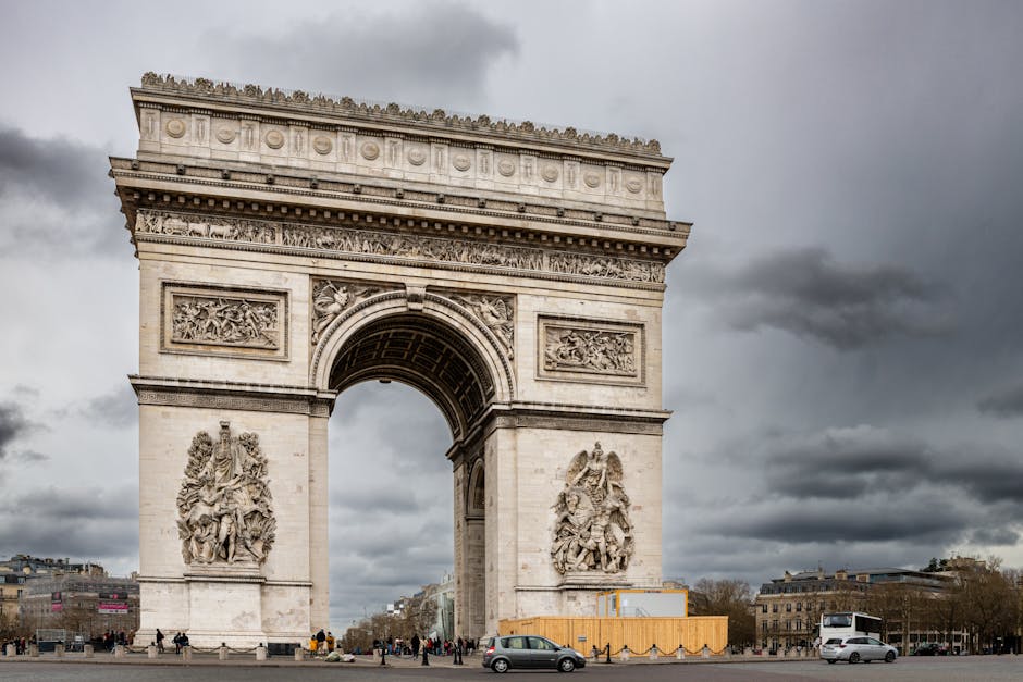 Capture of Arc de Triomphe, Paris on a cloudy day, showcasing historic architectural grandeur.