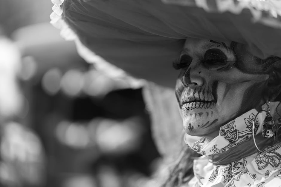 Close-up of a woman in traditional Catrina makeup with an elaborate headdress in Mexico City.