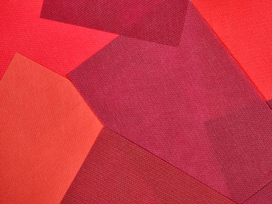 An eye-catching abstract design featuring vibrant red fabric textures in geometric patterns.
