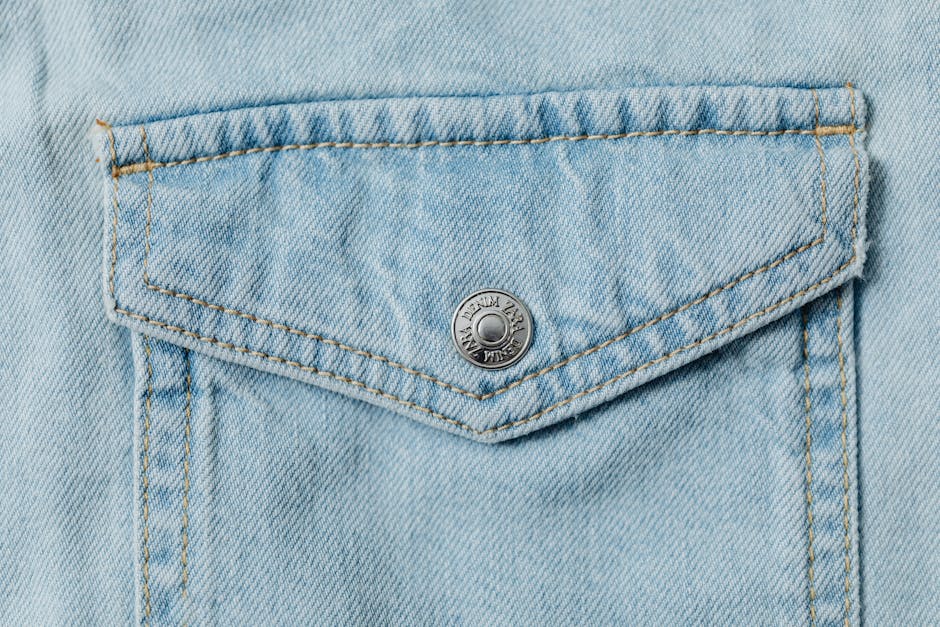 A detailed view of a stylish denim pocket showcasing stitch work and texture.