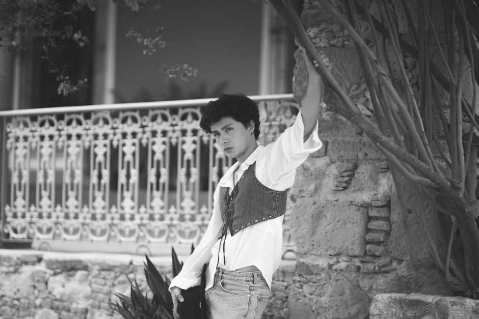 Stylish black and white portrait of a person outdoors, embodying modern fashion.