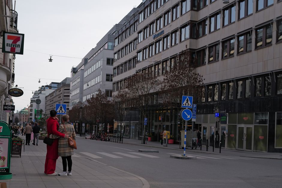Pedestrians on a lively street in Stockholm, showcasing urban life in Sweden.